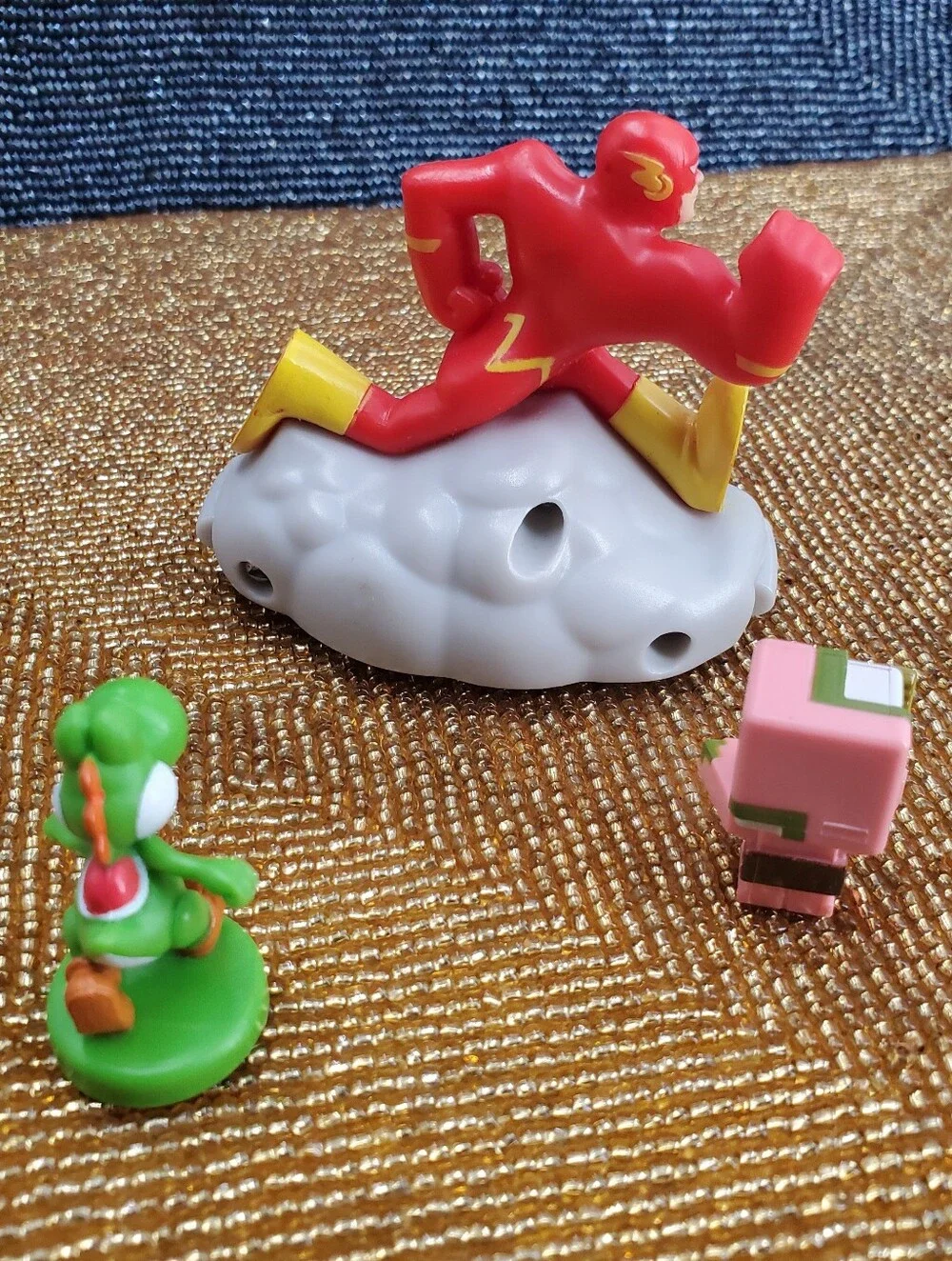 Mix of 9  small toy figures, miniature vehicles, and character charms. (C40)